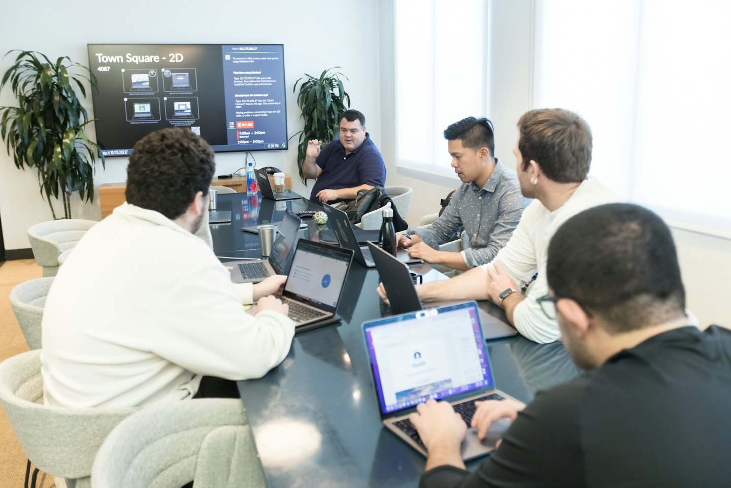 Diverse professionals collaborating around a conference table in a modern office.